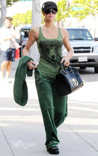Paris Hilton walks in Beverly Hills wearing green Juicy Couture tracksuit