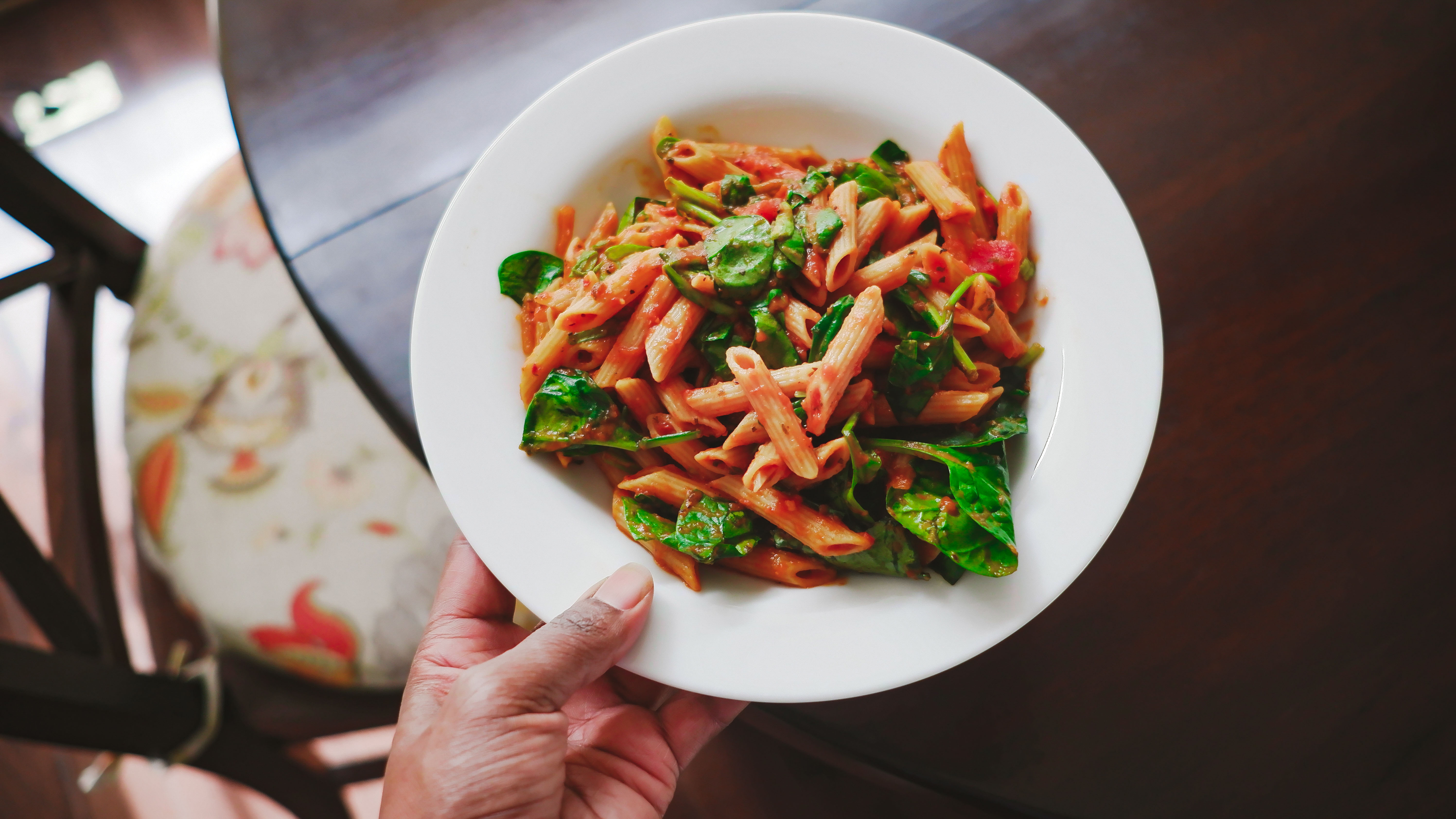 Woman holding plate of pasta health