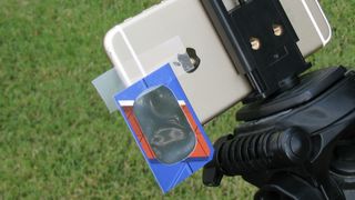 A pair of solar eclipse glasses can be made into a simple solar filter for a smartphone