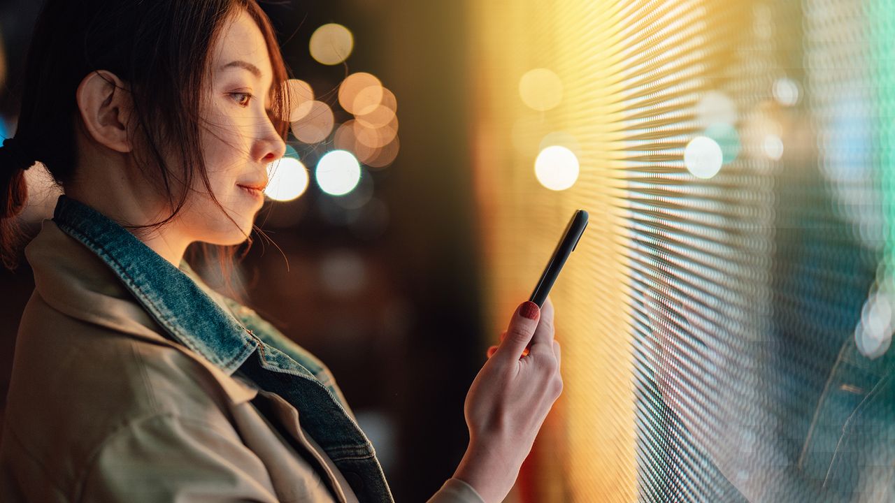 Young woman using a smart phone with AI