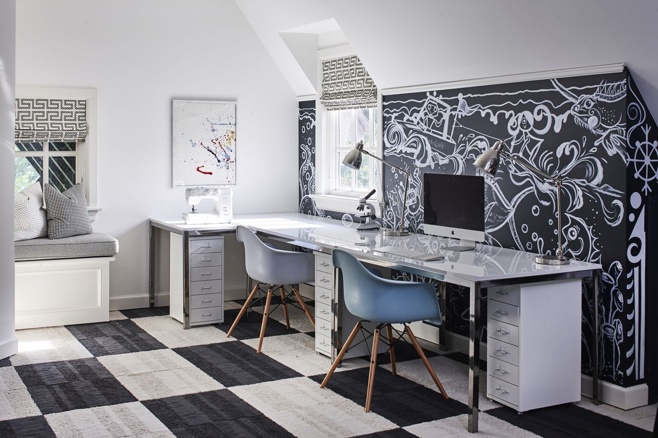 A kid&#039;s study room with a large chalkboard paint wall