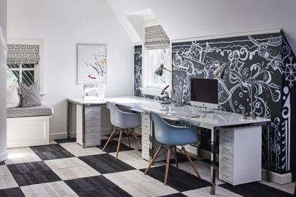 A kid's study room with a large chalkboard paint wall