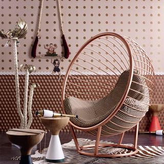 room with bubble chair and dotted printed pattern on wall