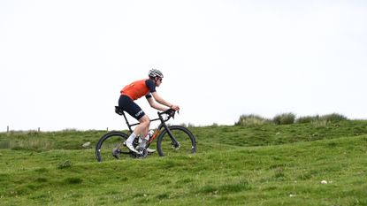 Male cyclist riding on a false flat climb
