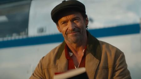 Hugh Jackman smiling before reading in The Sheep Detectives.