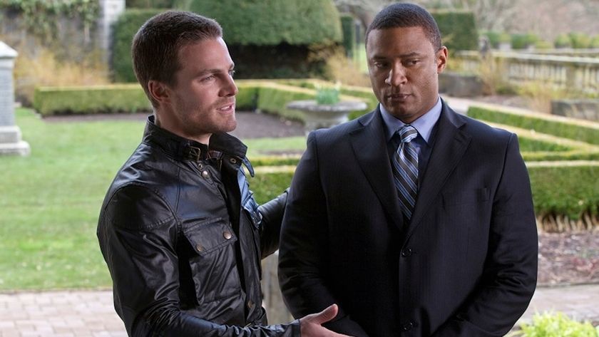 Oliver Queen standing next to John Diggle in Arrow Season 1