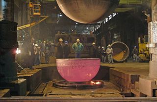 A new, slightly larger sphere was forged from titanium to replace the old personnel sphere. Above, one of two new hemispheres cools