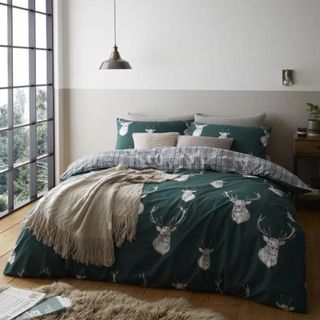 Green stag Christmas bedding in a white bedroom