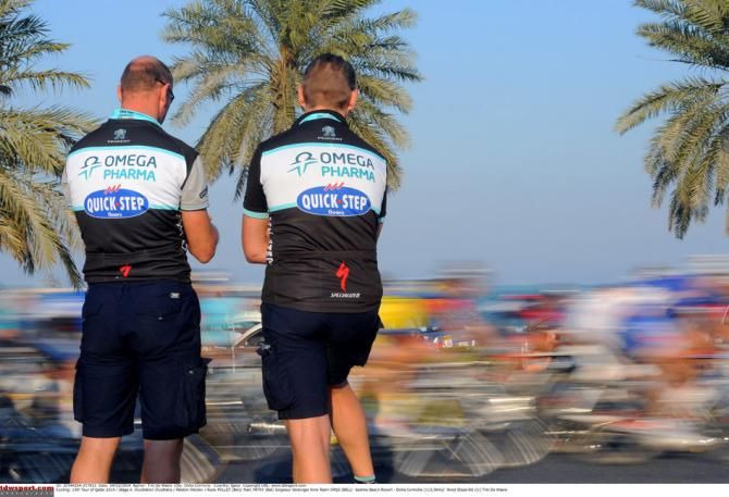 Two Omega Pharma-QuickStep soigneurs watch as the peloton go by