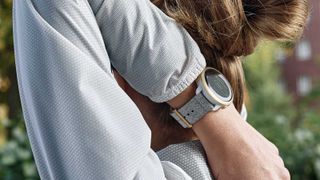 Suunto vs Garmin: person stretching wearing a Suunto watch