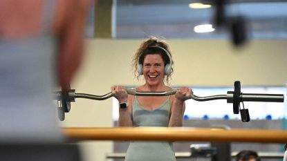 On the day the gyms reopen in England, a woman works out at Clissold Leisure Centre in London