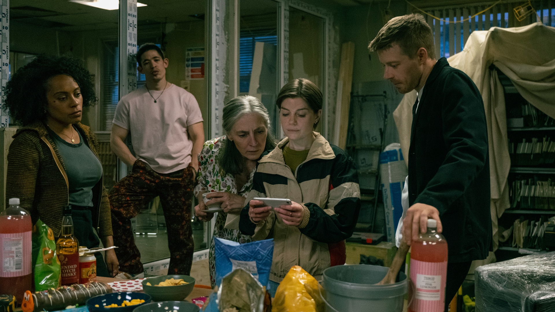 The Slow Horses team gather round a phone in Slow Horses season 5