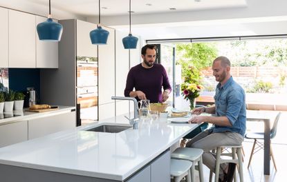 modern kitchen with white worktop in an open plan space with bifolds