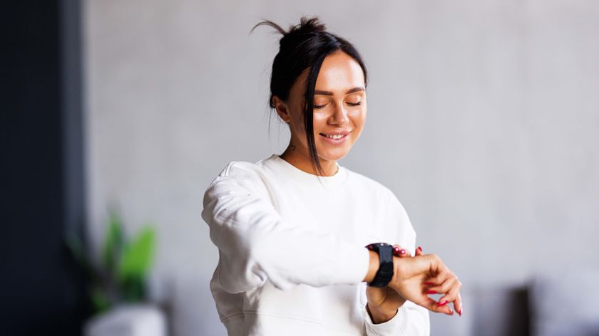 a photo of a woman looking at her fitness tracker