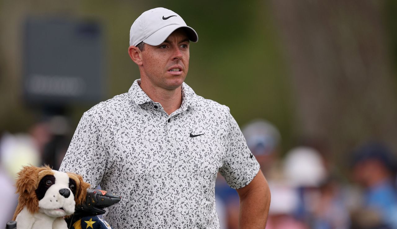 McIlroy looks on with his bag beside him