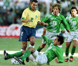 Brazil's Cafu is dispossessed by Bolivia's Marco Sandy in the final of the Copa America in 1997.
