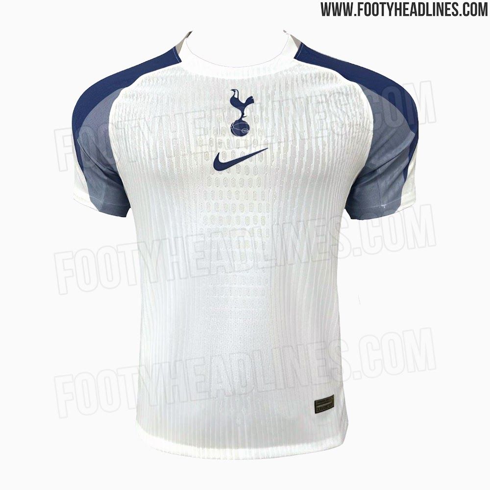 A white shirt with a navy blue tick on the sternum and a bird standing on a ball just above it and navy sleeves