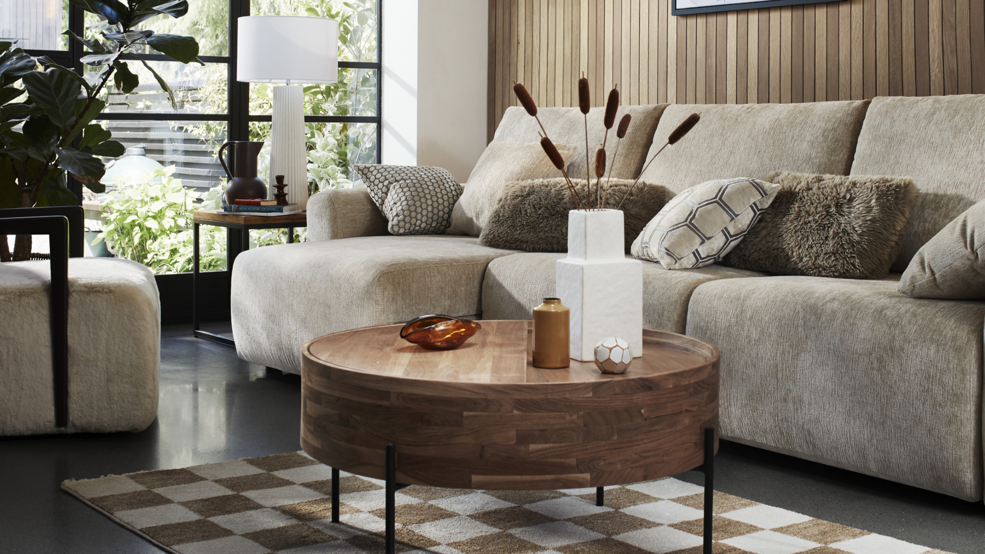 The Furniture Village x Ideal Home Gemini sofa in a living room with wall panelling and a round wooden coffee table