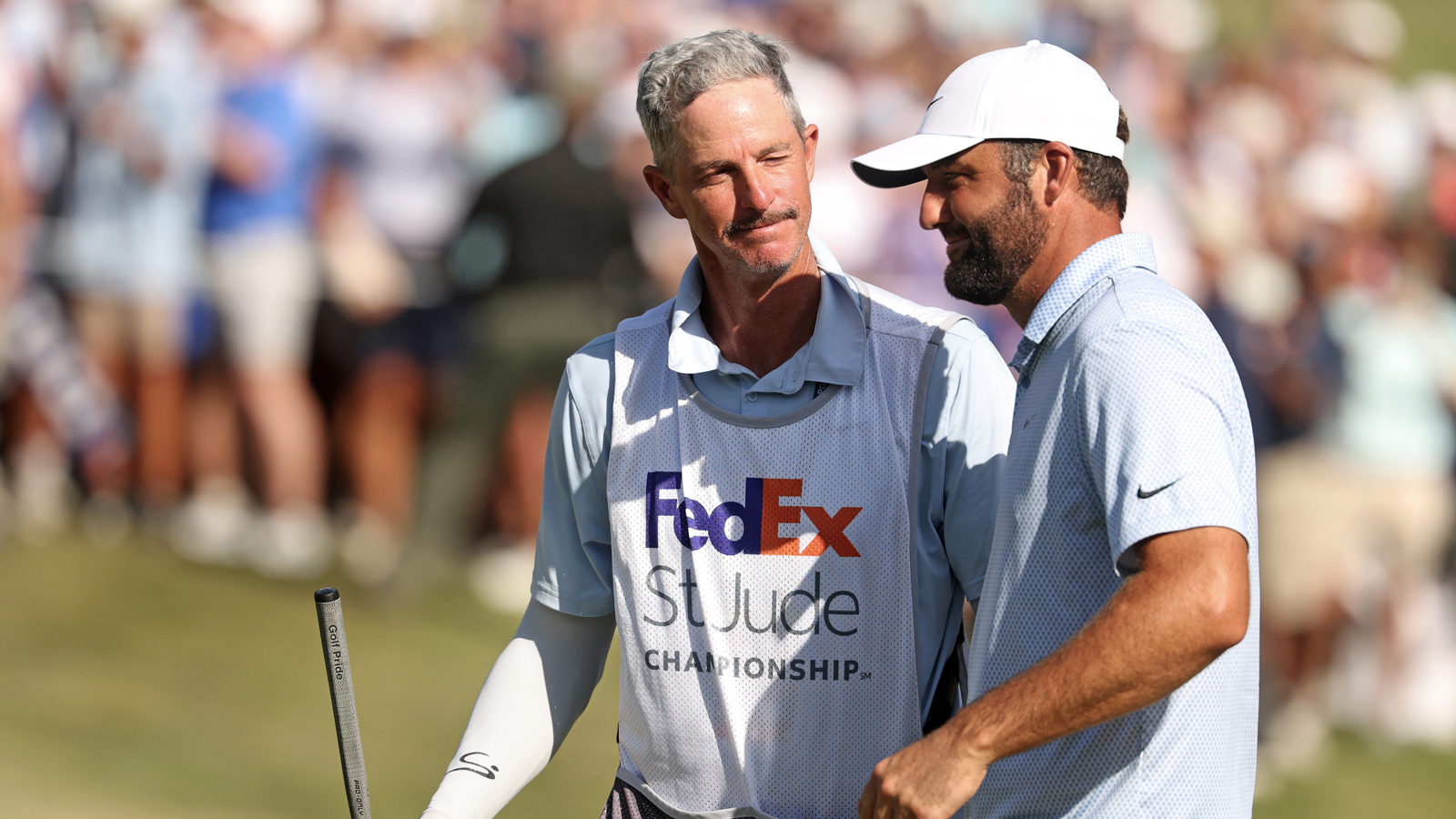 Ted Scott and Scottie Scheffler celebrate walking off the 18th green