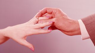 UNITED STATES - CIRCA 1960s: Man placing engagement ring on woman's finger. (Photo by H. Armstrong Roberts/Retrofile/Getty Images)