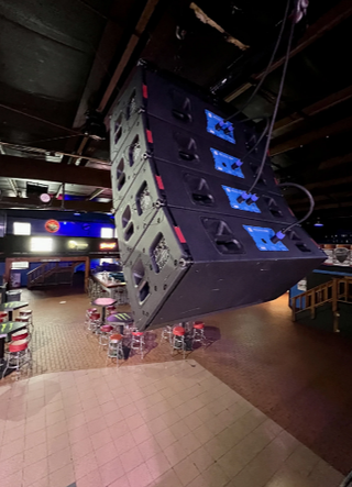 A JBL line array hanging next to the stage ay Pop's.