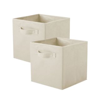 Two beige fabric storage cube bins turned to the left, with handles on the front