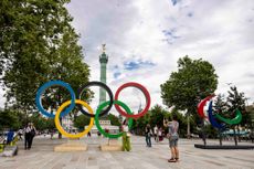 Visitors take photos next to Olympic and Paraolympic rings near Plaza de la Bastilla ahead of Paris 2024 Olympic Games