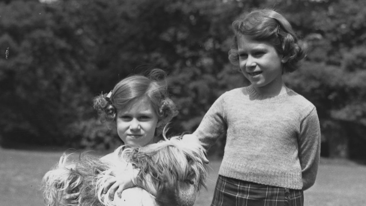 june 1936 queen elizabeth ii as princess elizabeth and her younger sister princess margaret 1930 2002 in the grounds of the royal lodge, windsor princess margaret is holding one of their pet dogs, a cairngorm terrier called chu chu photo by lisa sheridanstudio lisagetty images