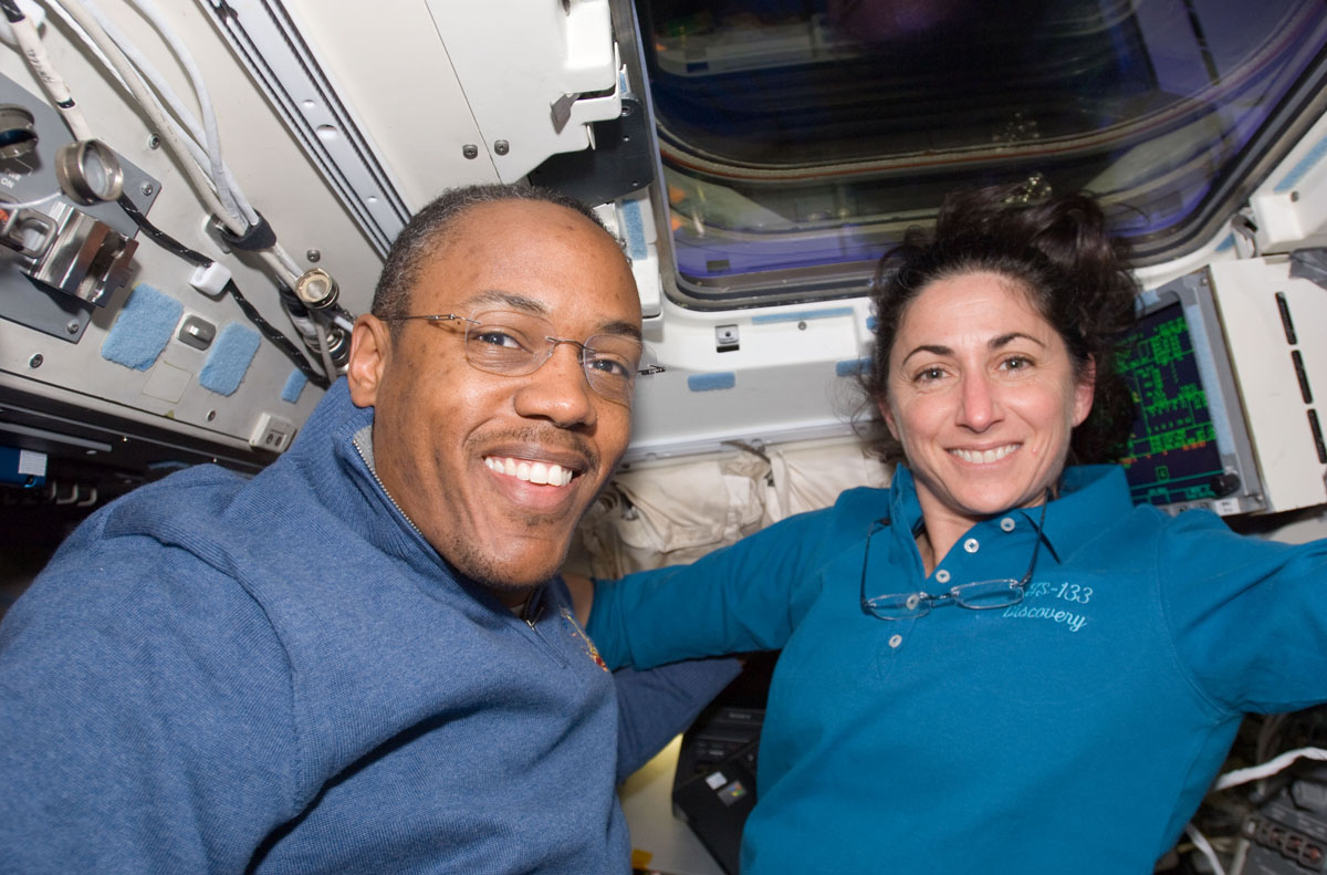 Astronauts Alvin Drew and Nicole Stott, both STS-133 mission specialists, take a break from flight day 2 duties on Discovery&#039;s aft flight deck on Feb. 25, 2011 during the STS-133 mission.