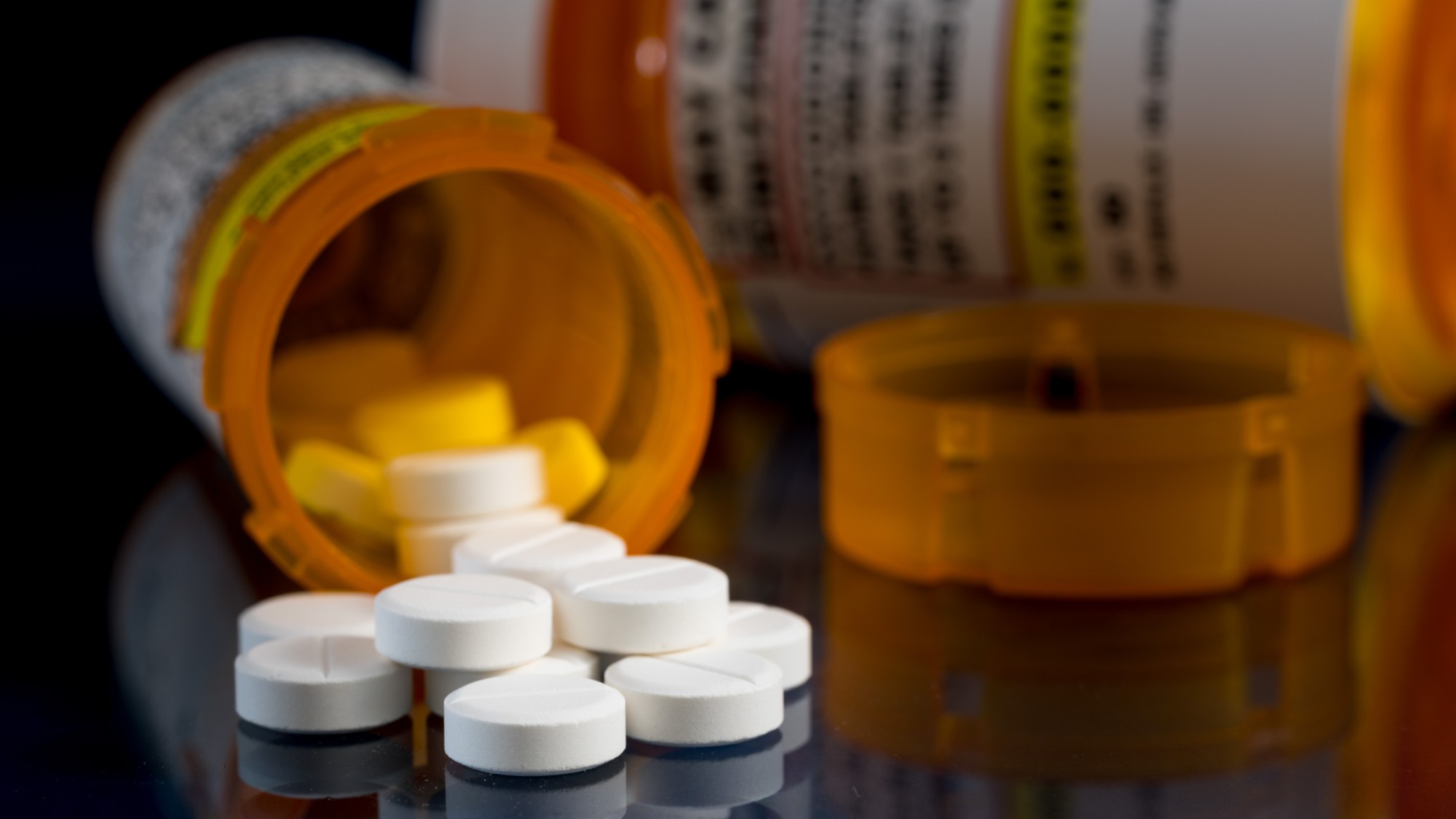 A stock photo of an open bottle of pills.