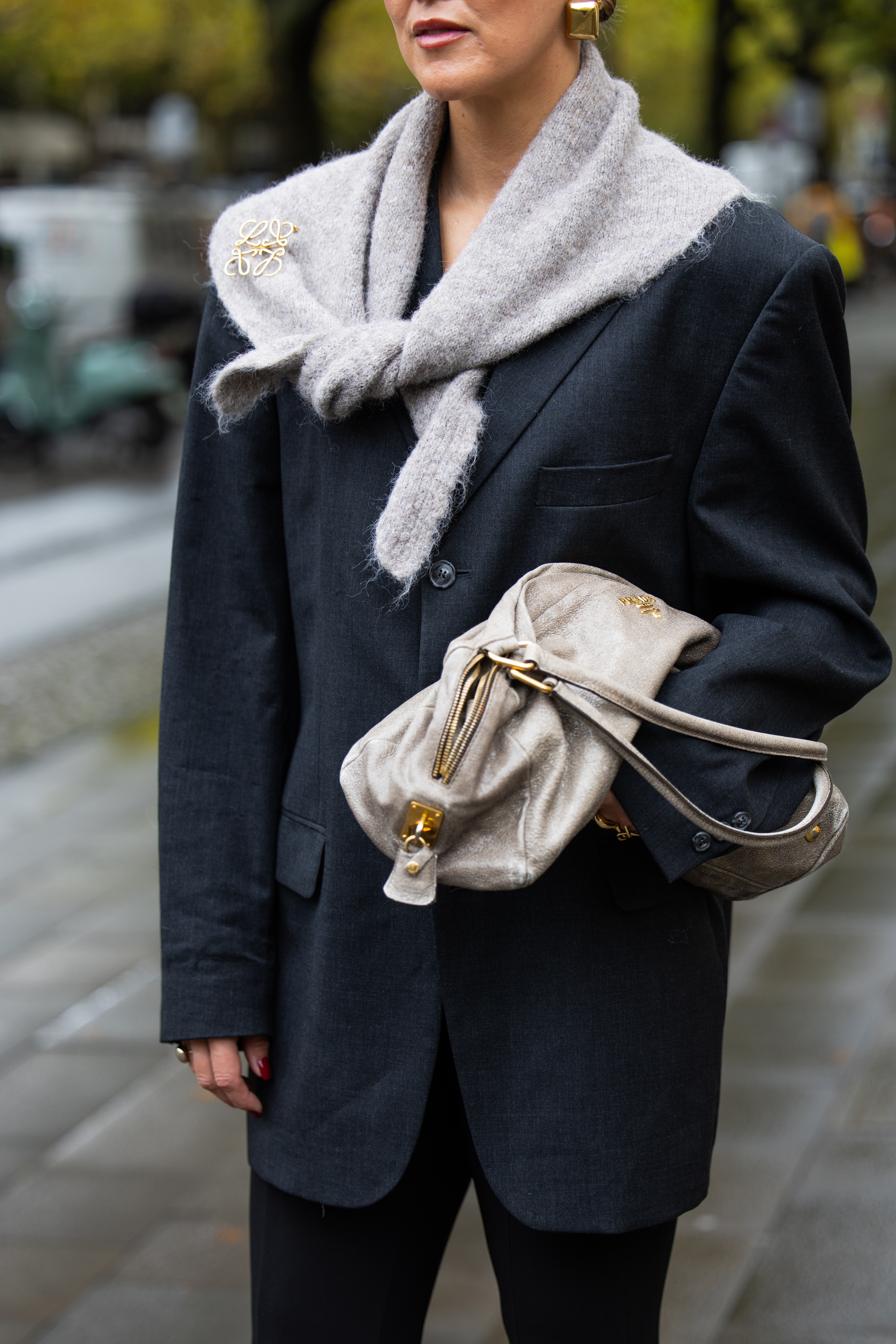 BERLIN, GERMANY - OCTOBER 08: Tina Haase wears vintage black oversize blazer, Black stirrup leggings, taupe knit triangle scarf Massimo Dutti, Loewe brooch, taupe grey Prada Bag on October 08, 2025 in Berlin, Germany. (Photo by Christian Vierig/Getty Images)