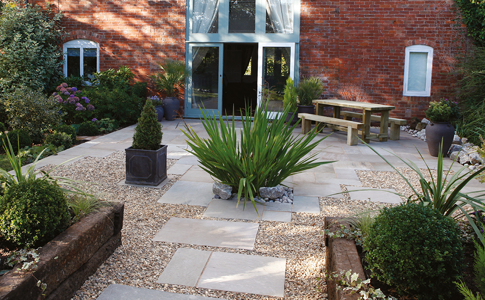 Natural Sandstone Paving in Autumn Green with borders and decorative planting