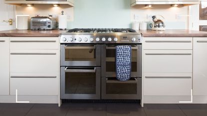 an oven in a white and wooden kitchen, to illustrate w&h's guide on how to clean an oven 