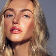 a headshot of a model with a streak of light over her face