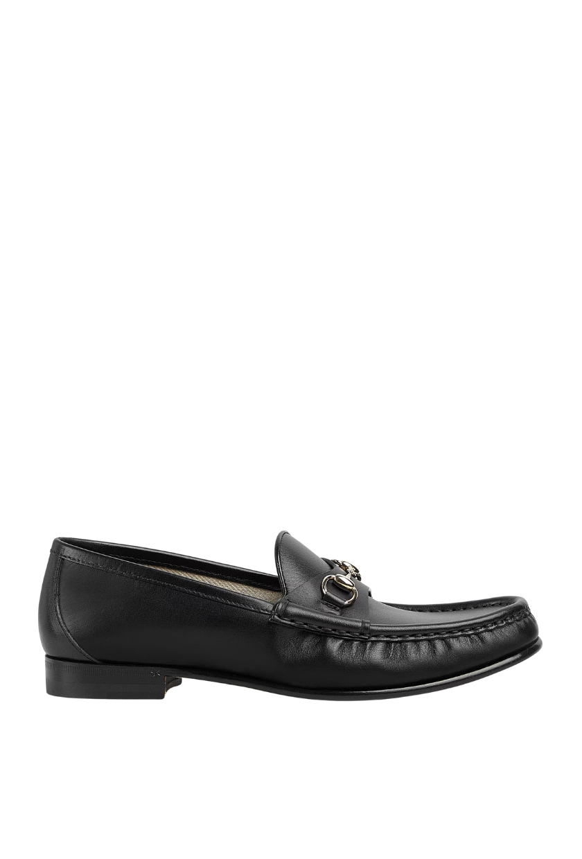 A pair of black ruched Gucci loafers. 