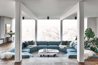 sunken blue sofa in a white living room