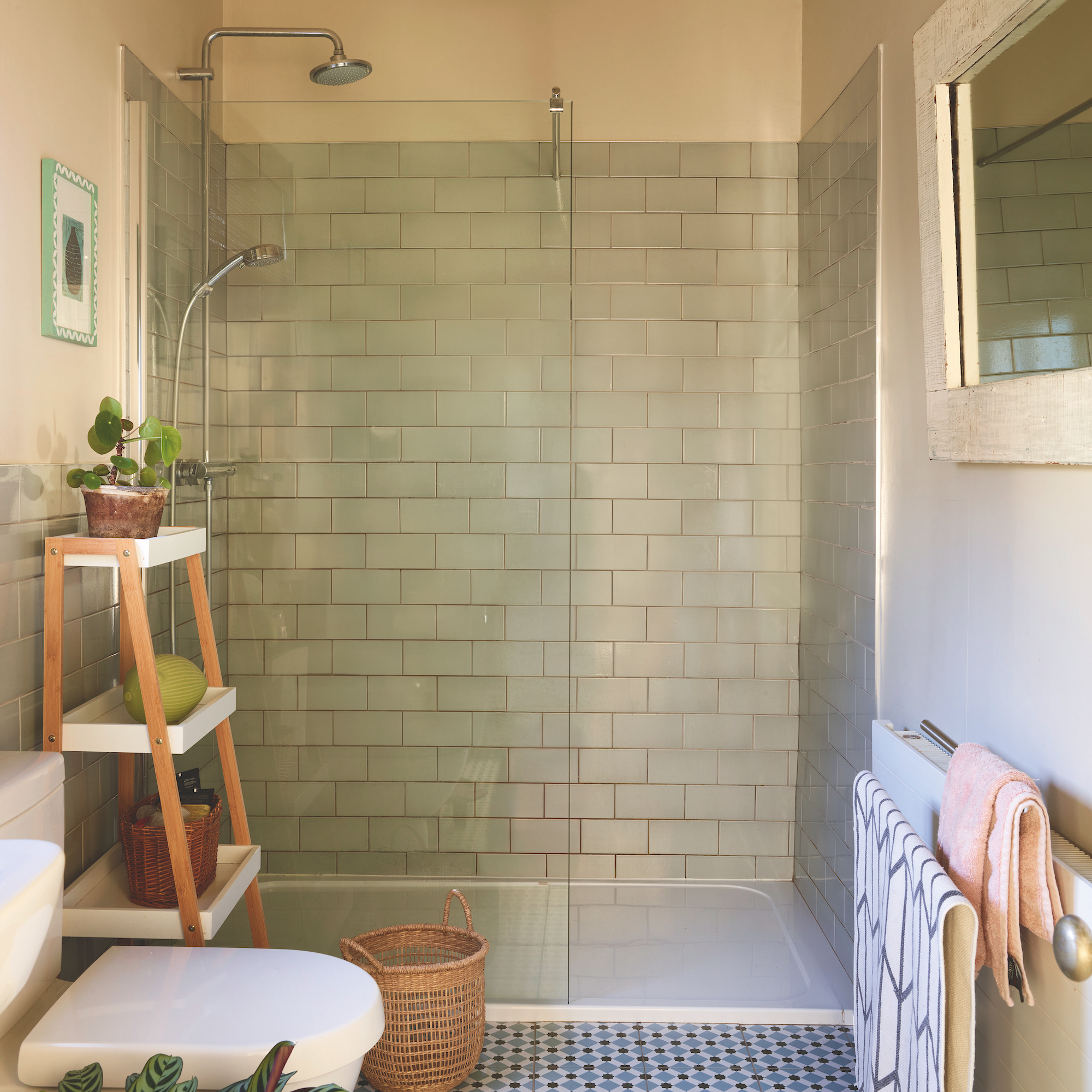 shower room with pale green metro tiles and blue pattern tiled floor