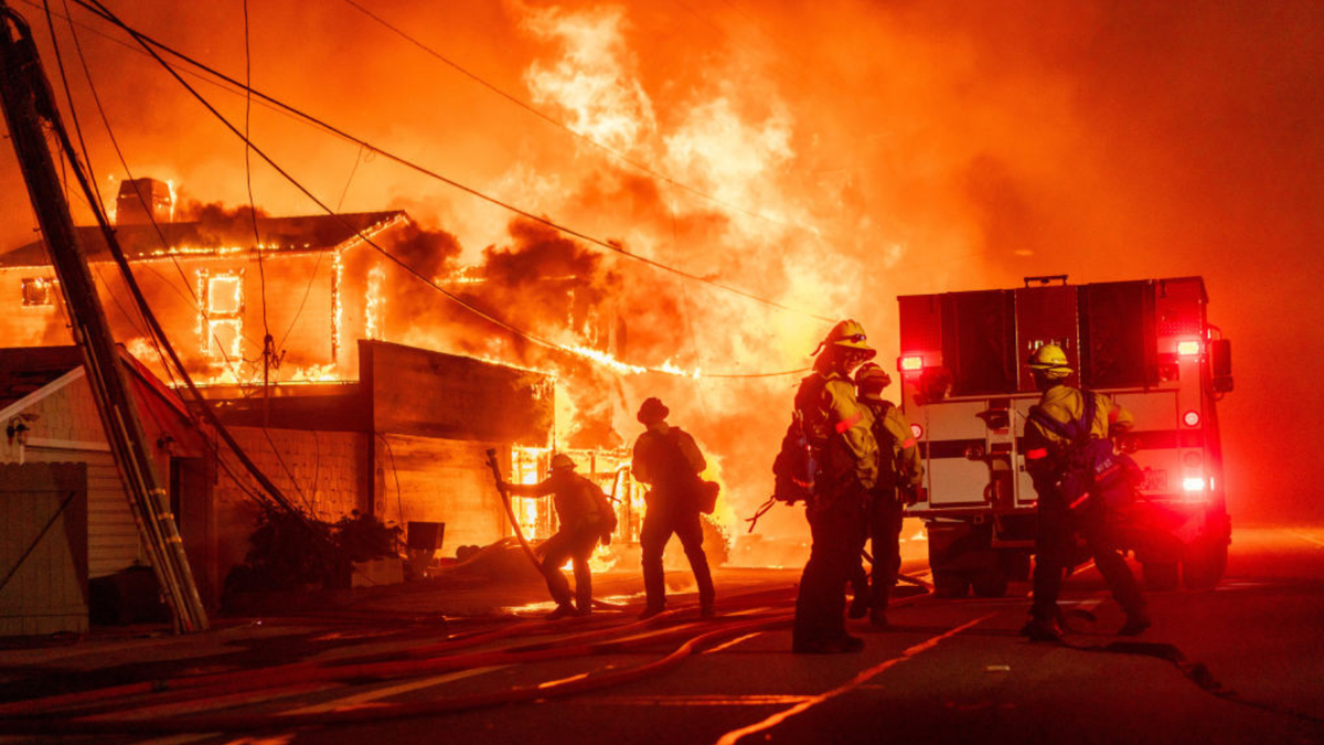 Firefighters battle flames during the Palisades Fire in the Pacific Palisades neighborhood of Los Angeles, California, US, on Tuesday, Jan. 7, 2025. A fast-moving wildfire ripped through an affluent neighborhood in Los Angeles, forcing thousands of people to evacuate as the region braced for a brutal wind storm that could last well into the weekend.