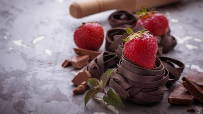 nests of freshly made chocolate pasta topped with strawberries
