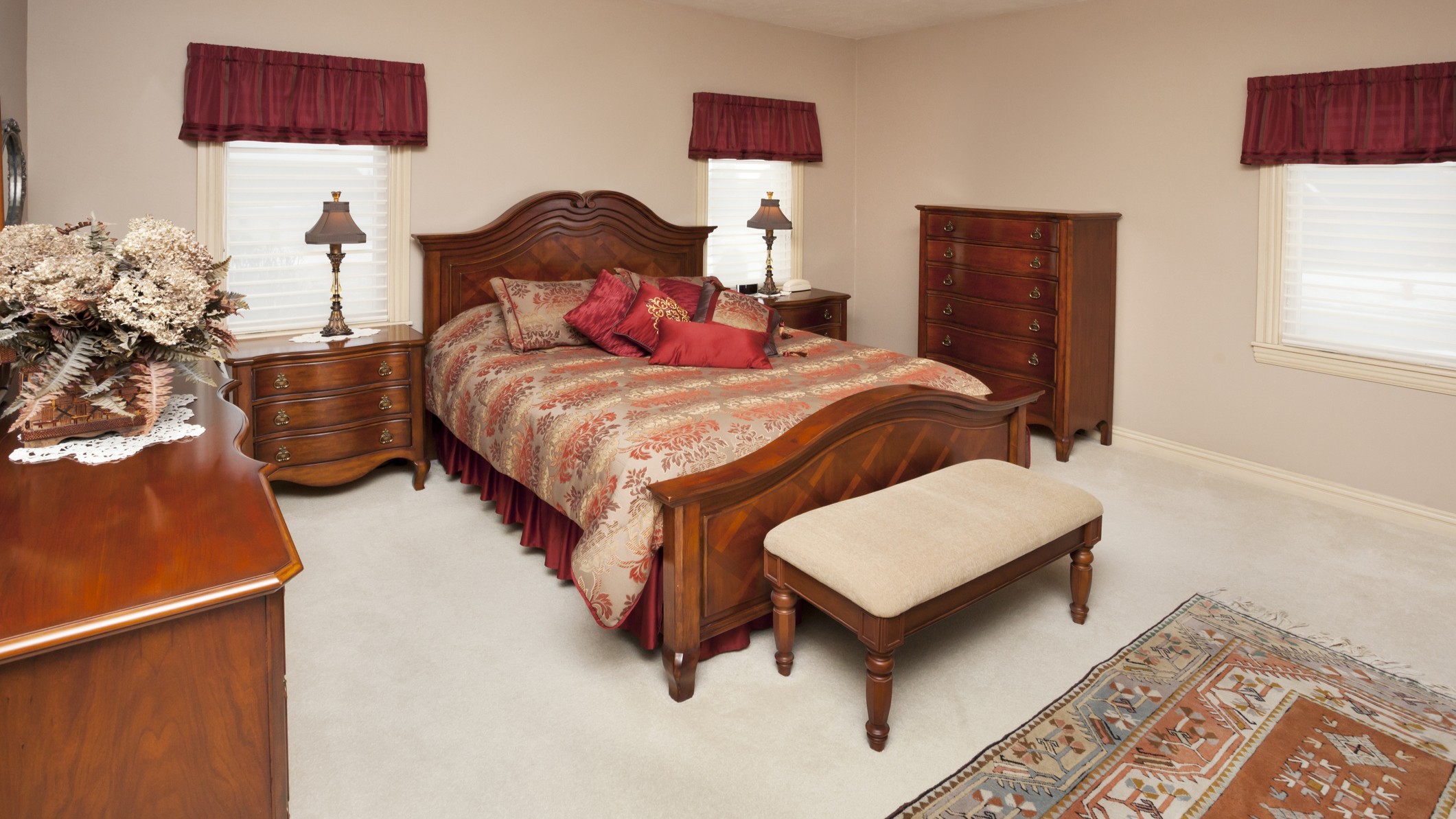 A dated, ugly bedroom set with matching wood furniture.