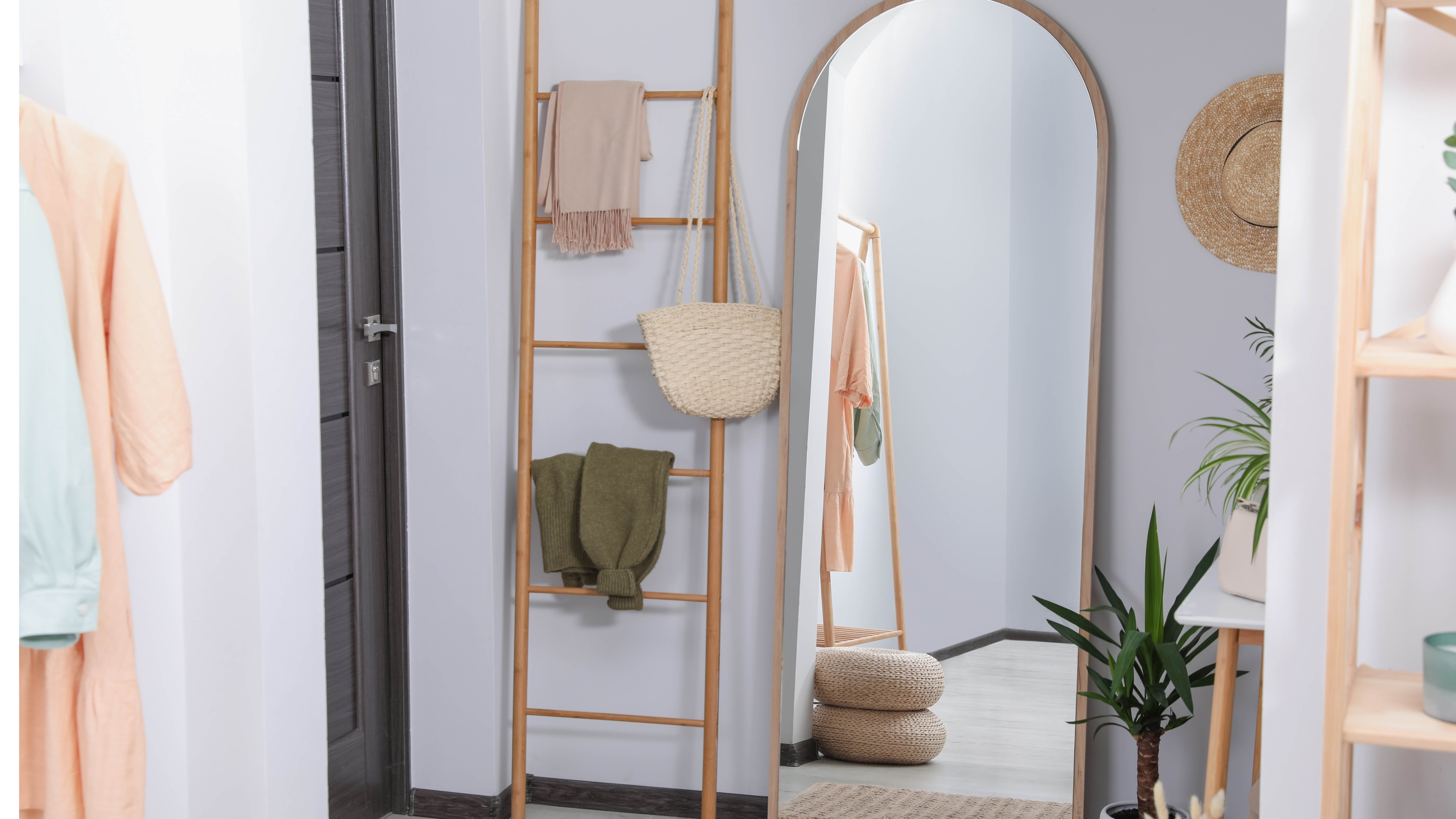 Wooden clothing ladder next to mirror