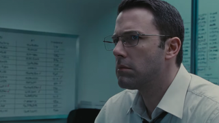 A still from the movie The Accountant in which Ben Affleck is wearing a white shirt and looking off camera.
