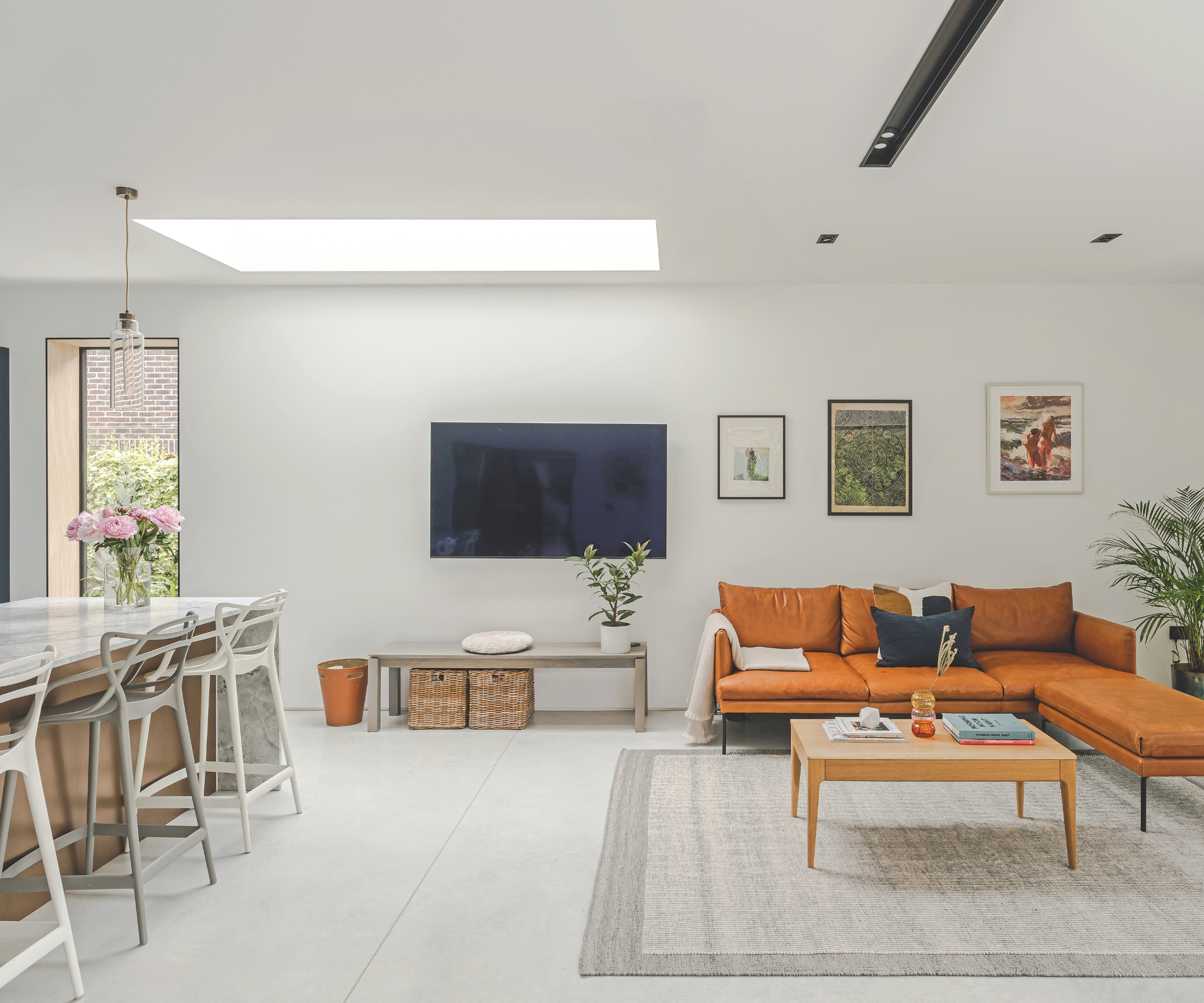 Living area with roof light and kitchen behind