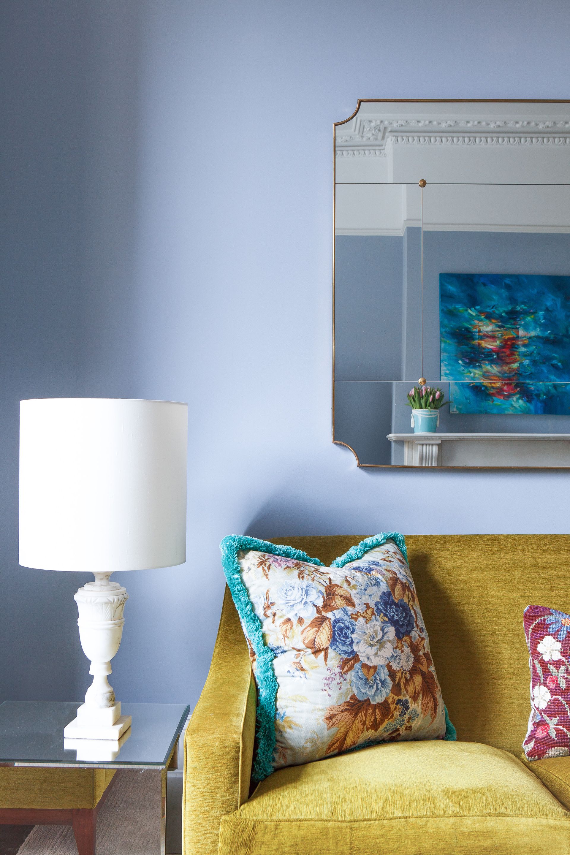 Mustard sofa against a light blue wall