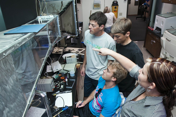 Former U.S. Marine Colleen Sevier discusses a project point with fellow USD engineering students in the lab.