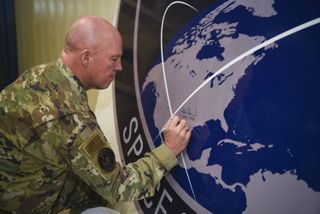 Gen. John Raymond, U.S. Space Force Chief of Space Operations, signs the United States Space Command sign inside the Perimeter Acquisition Radar building on Jan. 10, 2020, at Cavalier Air Force Station, North Dakota.