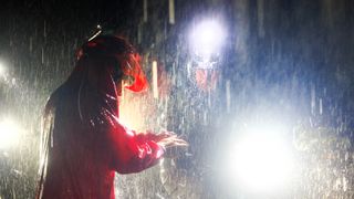 A race marshall and MTB rider in the pouring rain