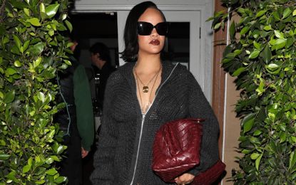 Rihanna wearing a see through sweater dress with a Bottega Veneta bag and thigh high boots