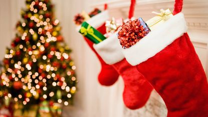 Stockings stuffed with presents hanging on a mantel