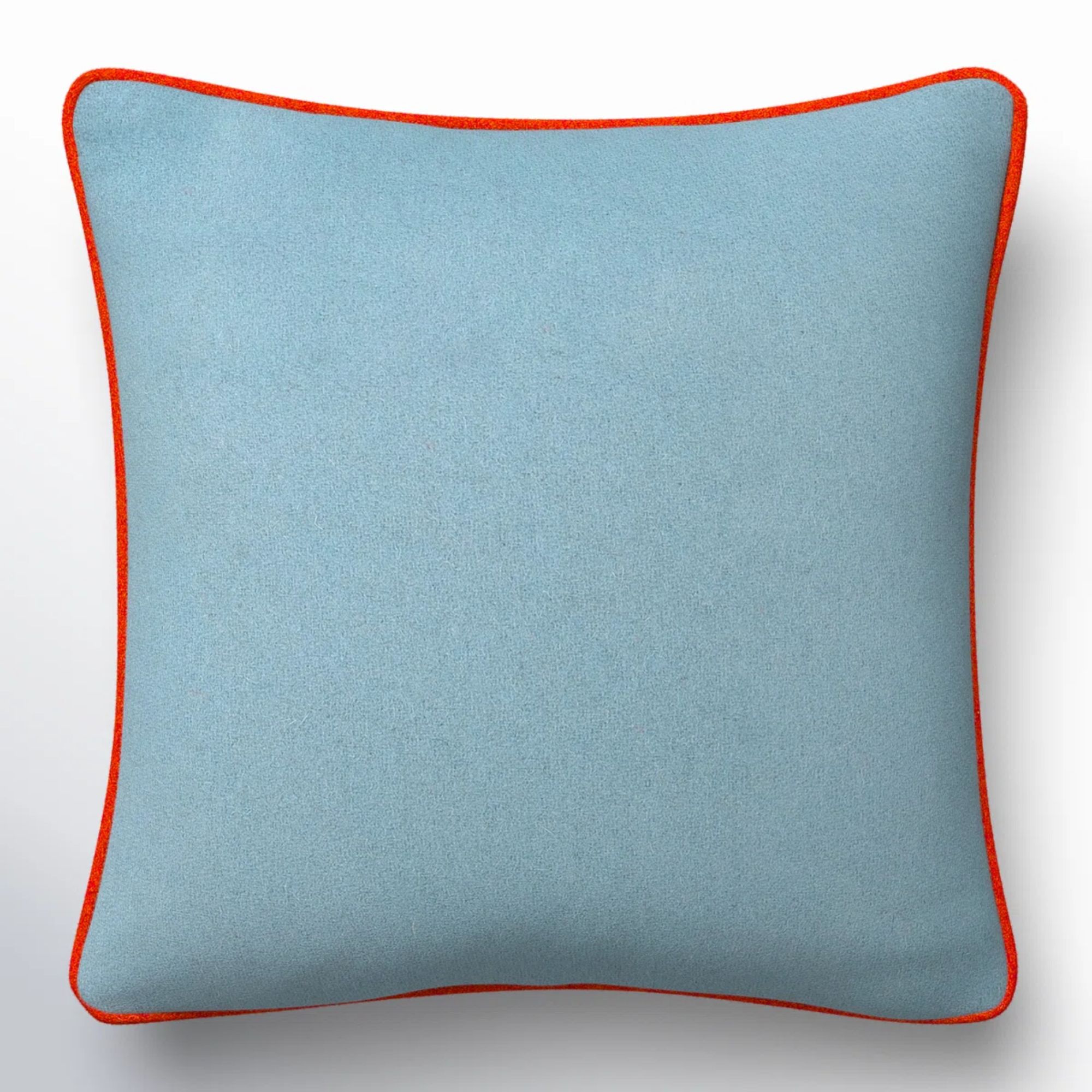 Pale blue pillow cover with red piping